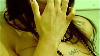 A young woman explores her body and reaches orgasm through solo masturbation