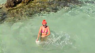 Pink bikini shining in a beautiful bay by the beach