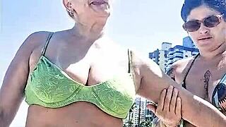Hey, check out me and my wild friend getting frisky on the beach while everyone watches the steamy action unfold.